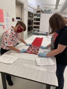 Students examine a textile